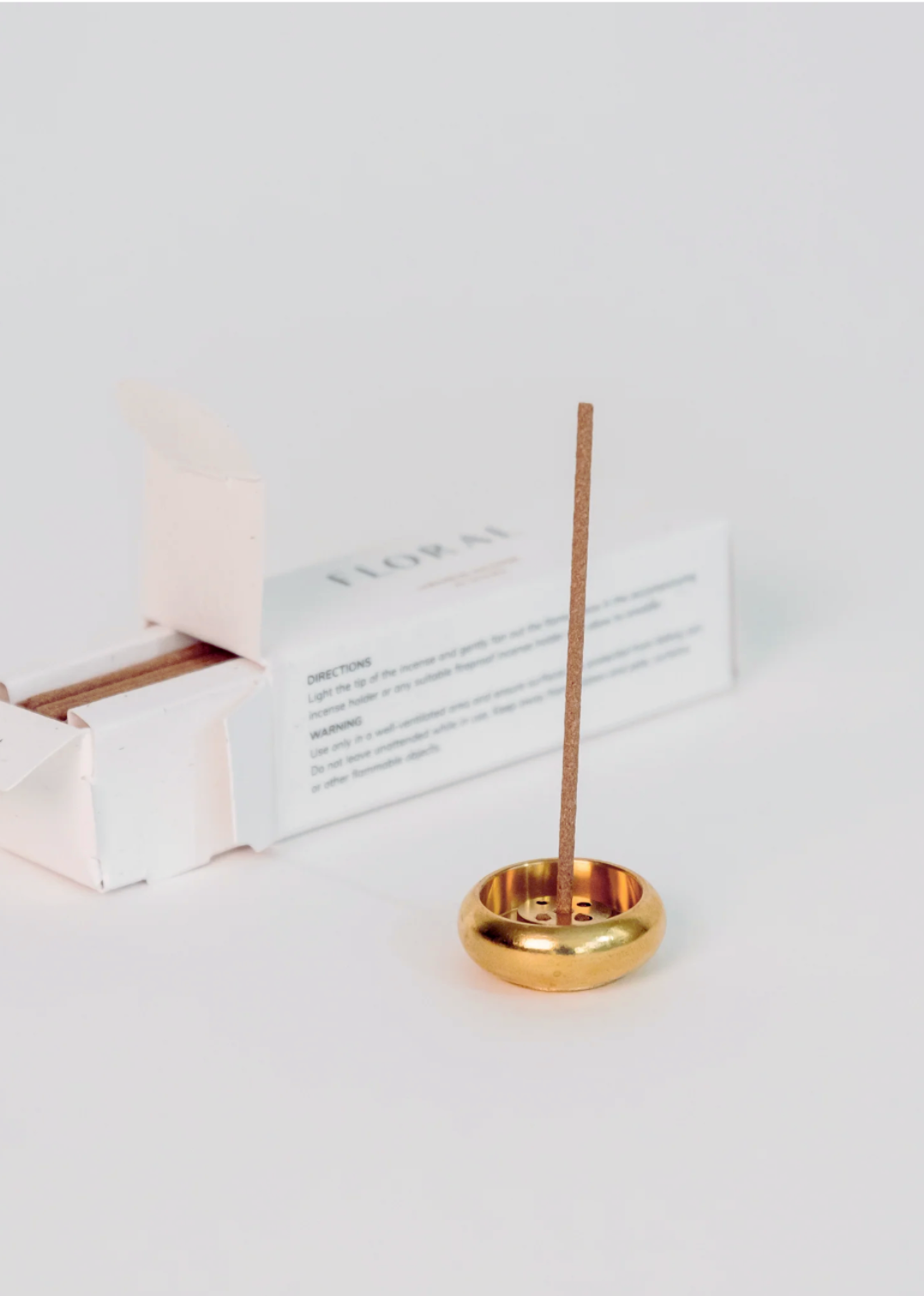 Brass bowl-shaped incense holder for stick and cone incense with minimalist design.