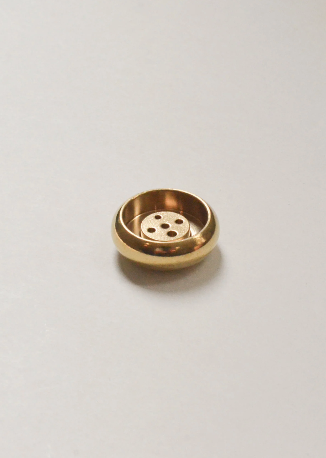 Compact and stylish brass incense dish for home fragrance and spiritual rituals.