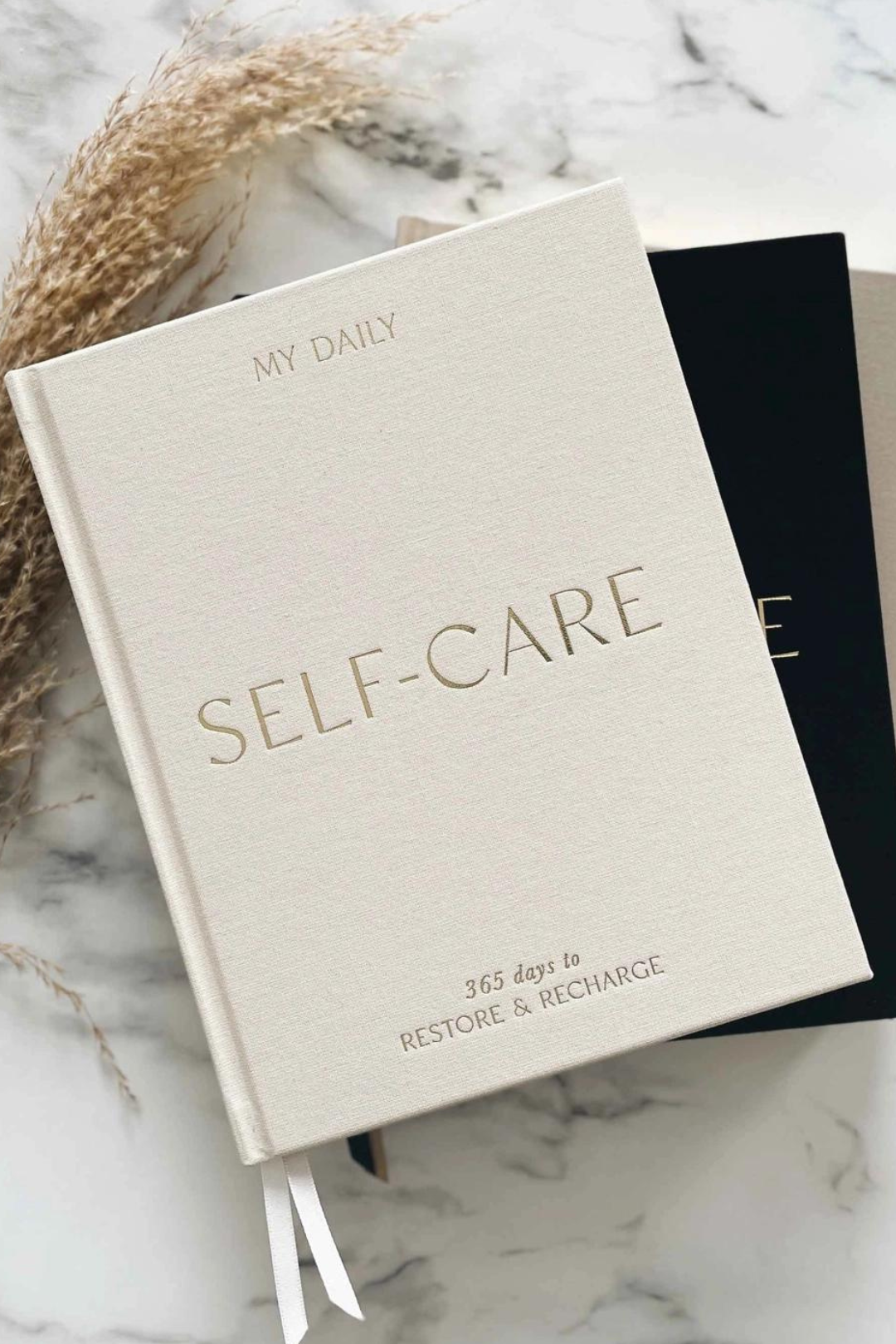 Self-care reflection journal featuring prompts for daily reflection and self-awareness, helping you nurture well-being and personal growth. This journal is sold at Blackbird Designs and made by Blush and Gold Journals.