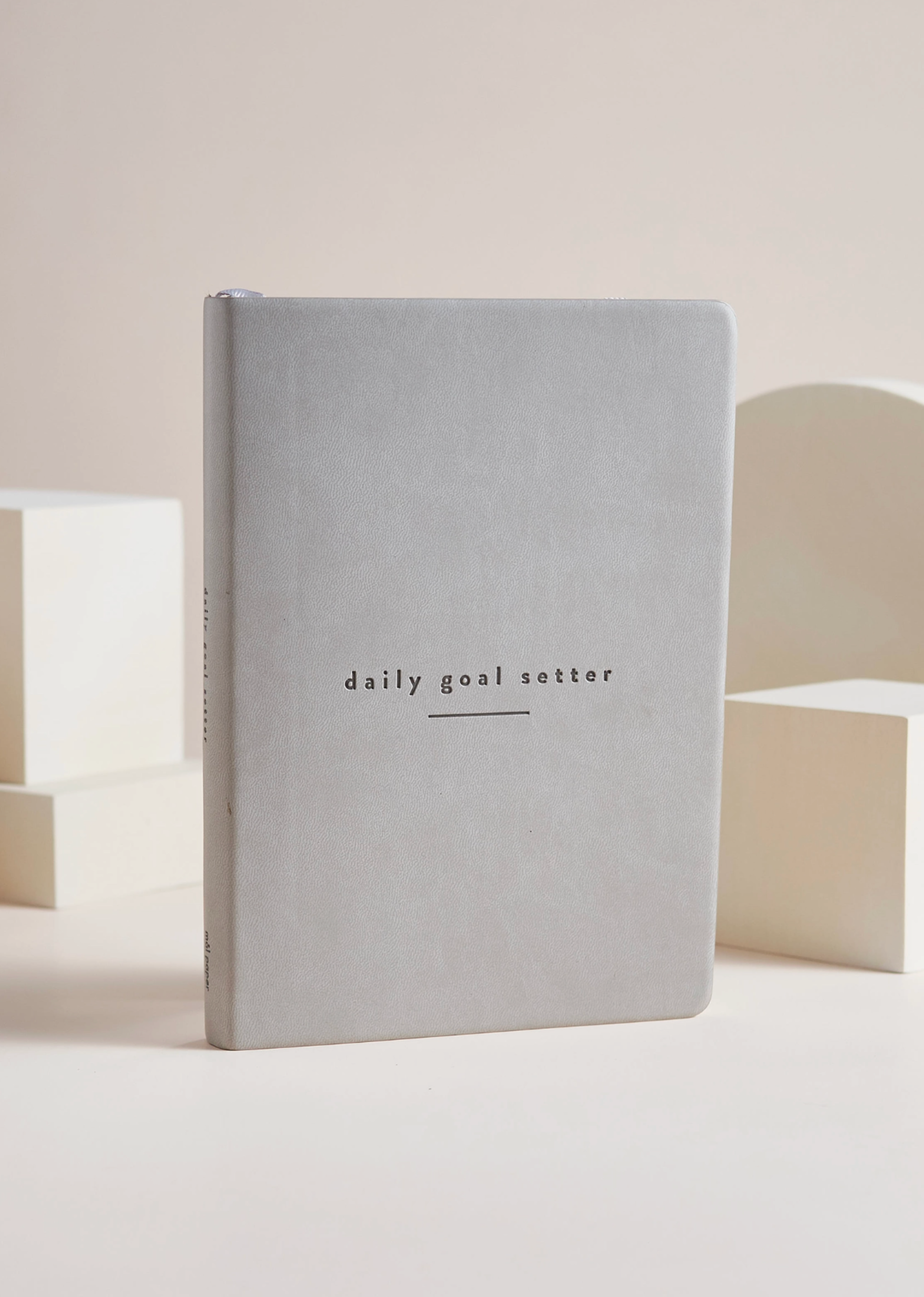 Photo of the grey minimalist planner with guided prompts for goal-setting and personal growth from Blackbird Designs.