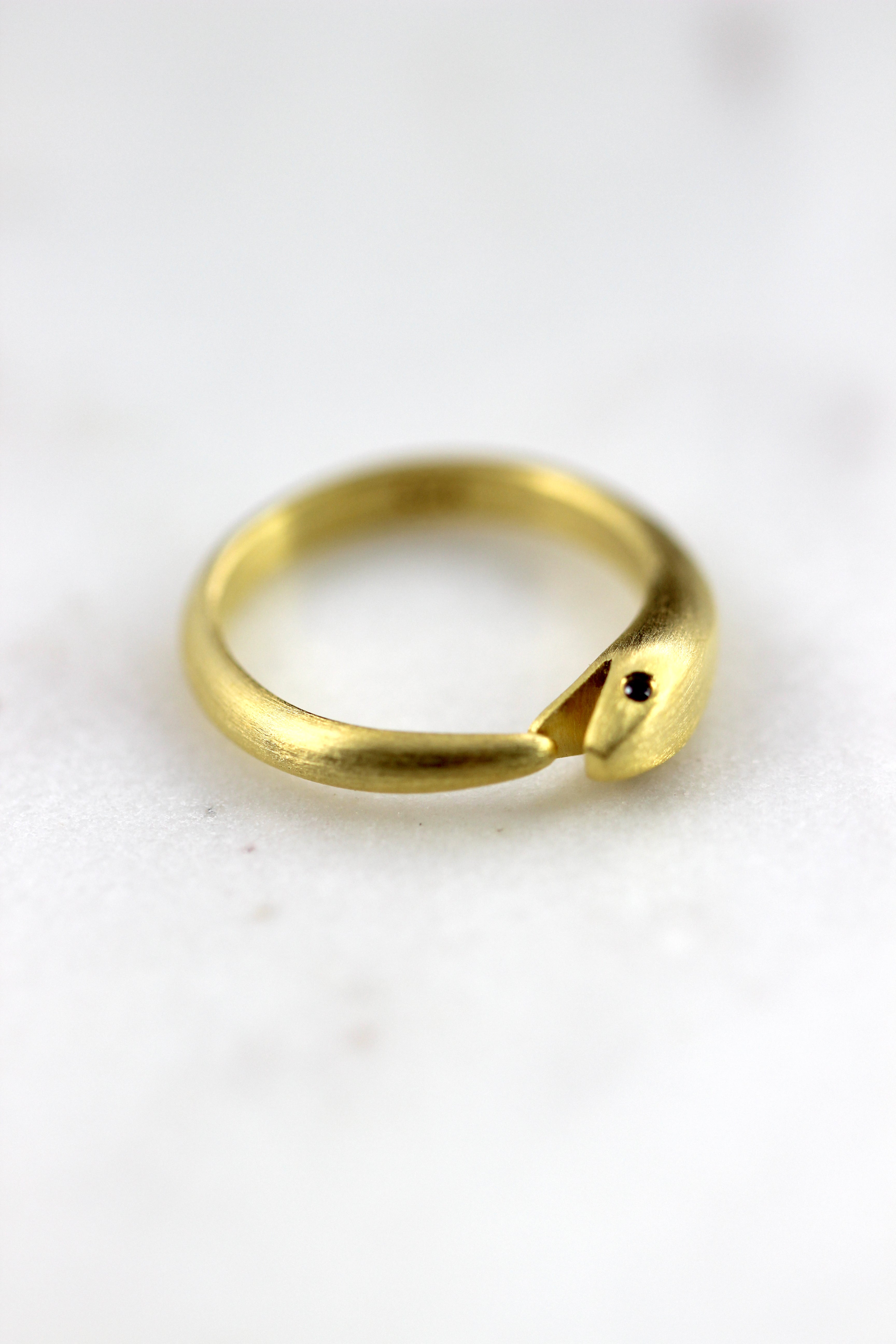 Photo of our Minimalist snake ring in gold vermeil featuring a wrap-around design from Blackbird Designs.